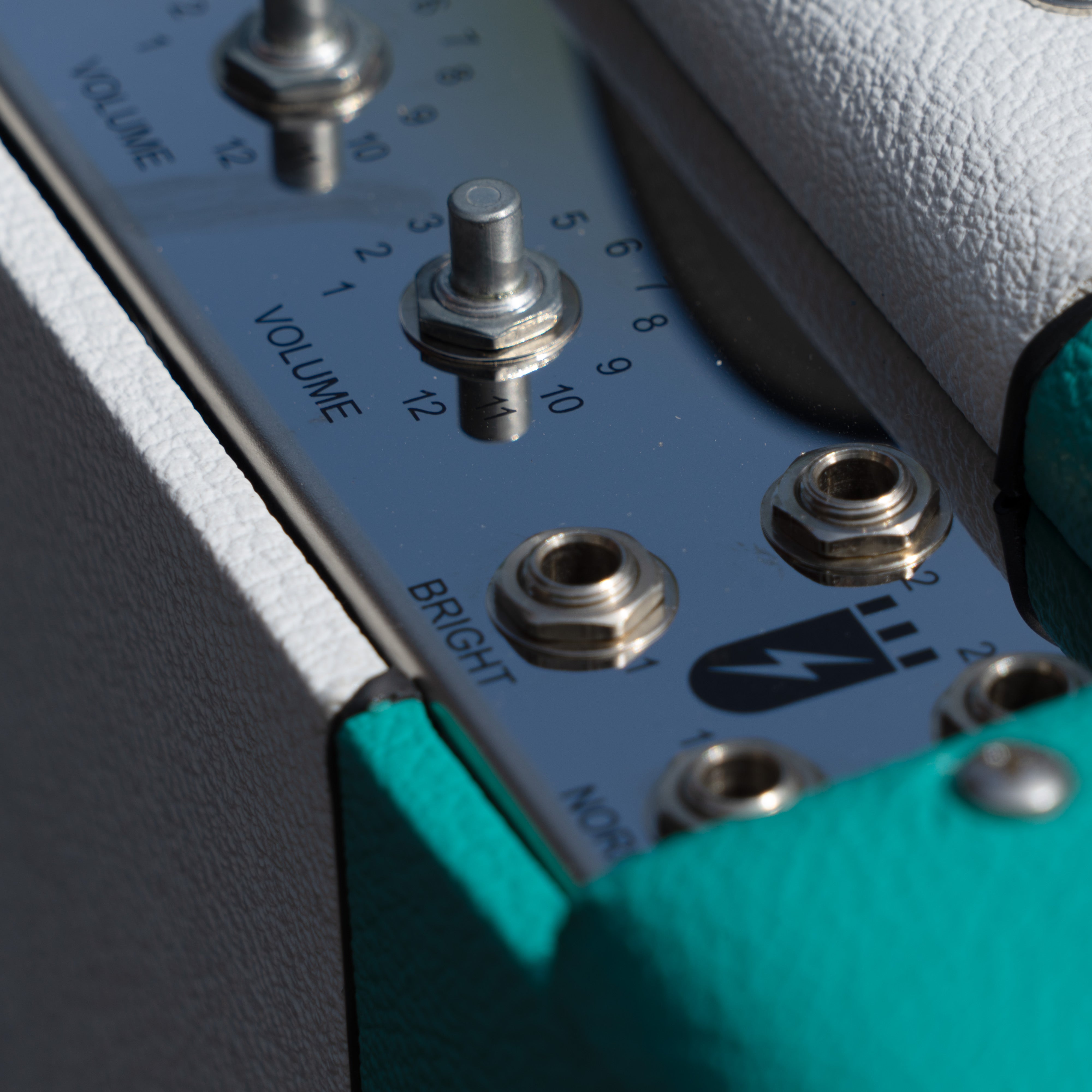 Teal & white narrow panel 5E3 Deluxe amplifier cabinet with chrome control panel, volume knobs, and input jacks.
