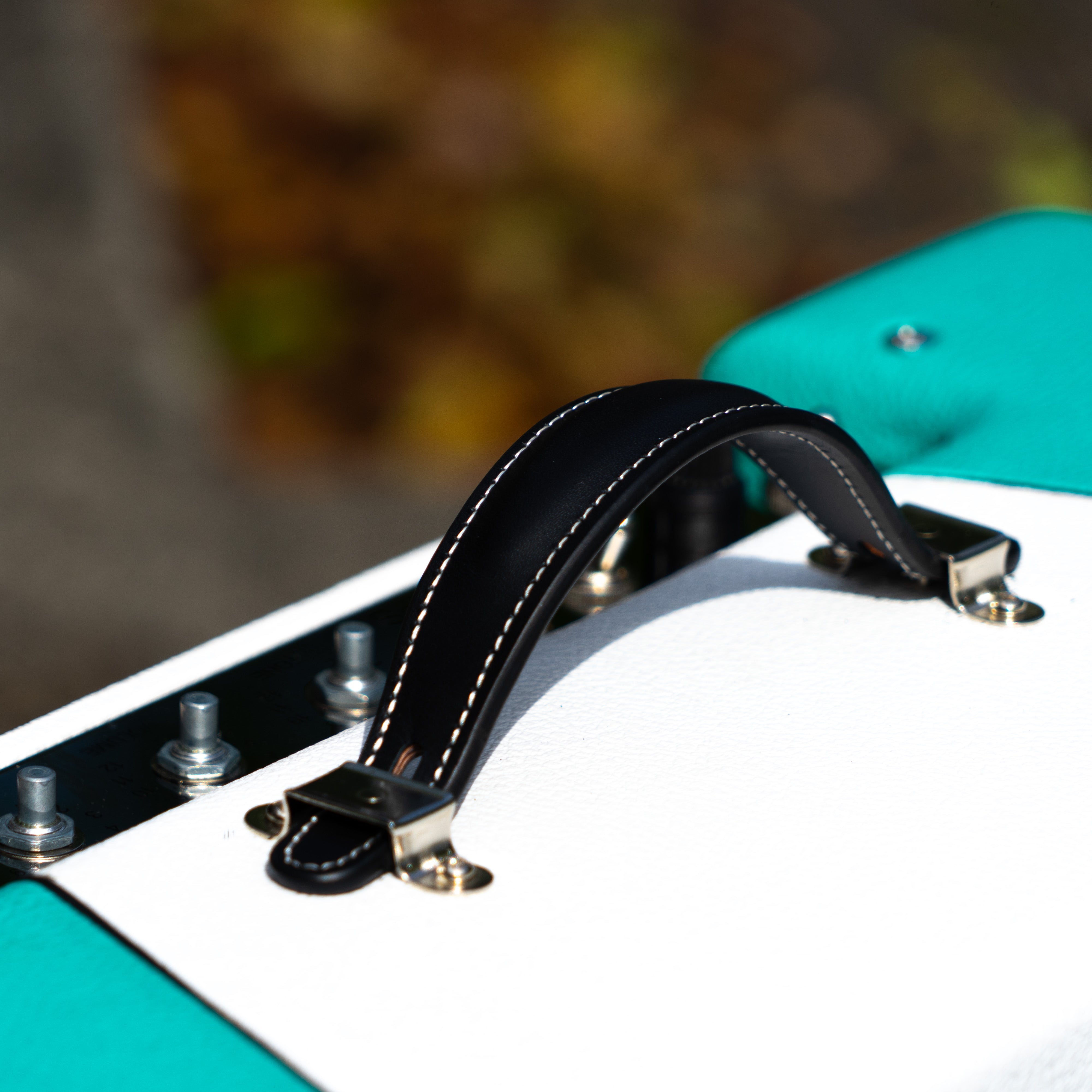 Teal & white narrow panel 5E3 Deluxe amplifier cabinet with a raised black handle and chrome glide feet.