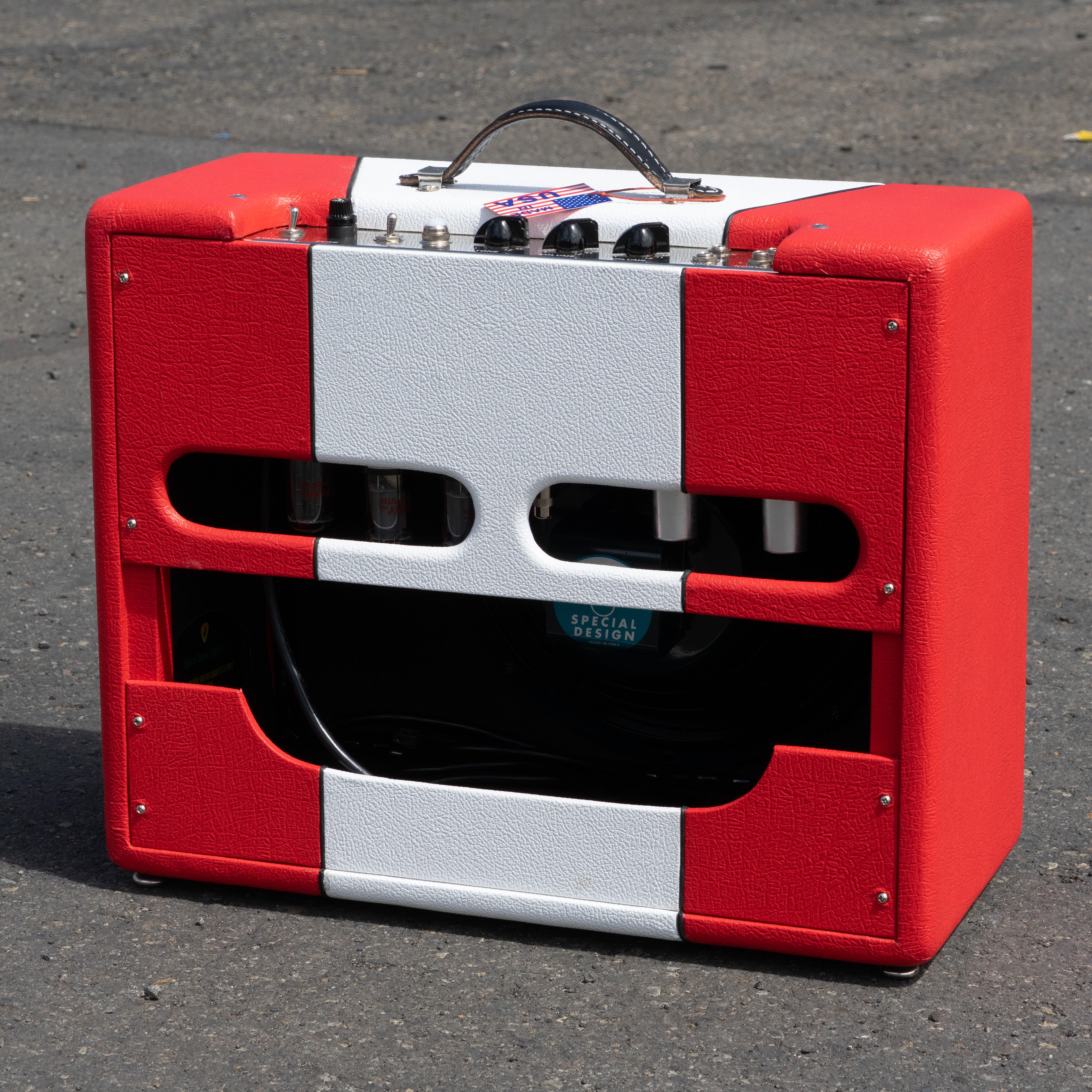 Red and white narrow panel 5E3 Deluxe amplifier with amber lacquer tweed, black handle, and visible vacuum tubes.
